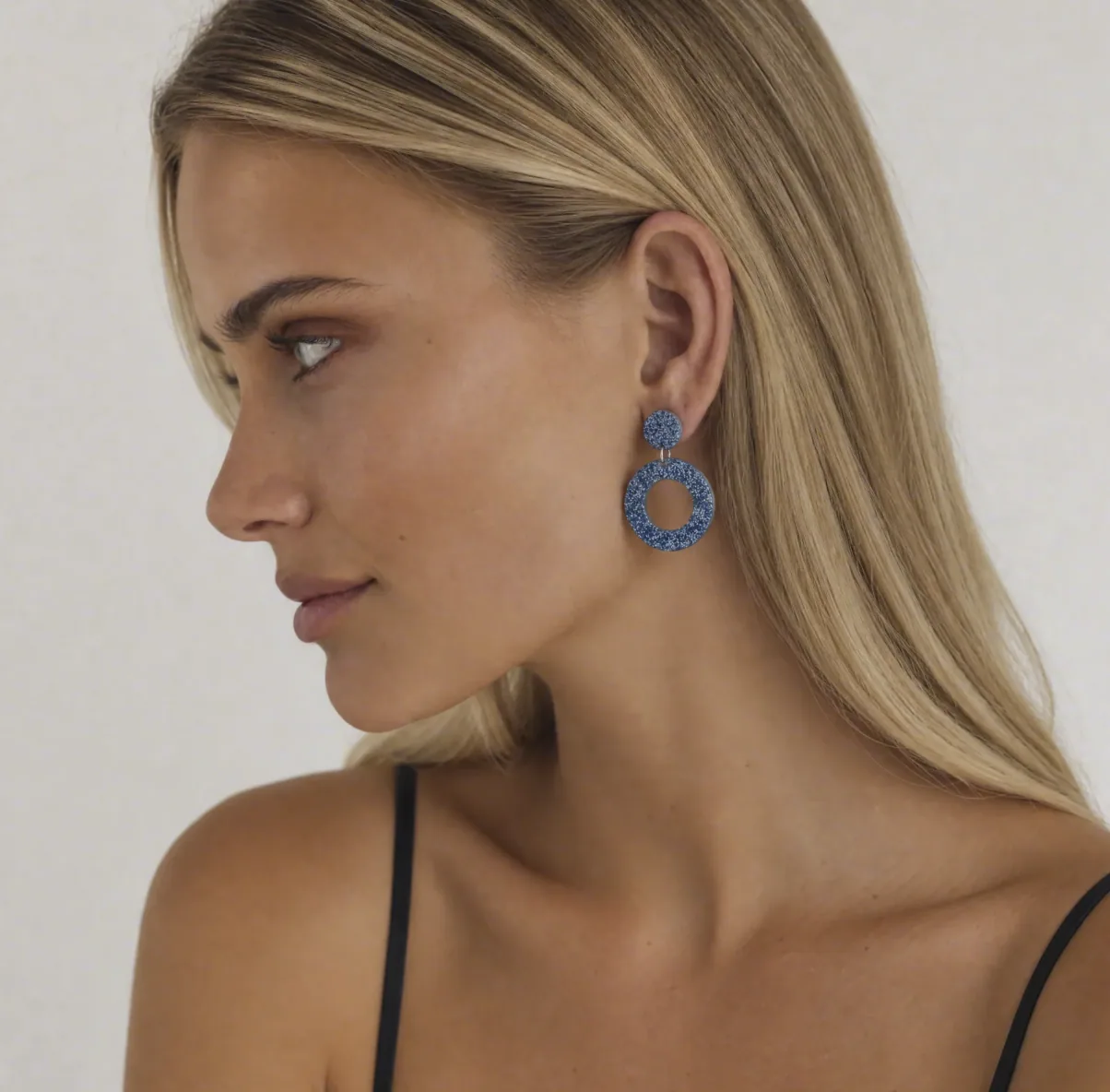 Model wearing blue glitter acrylic dangle earrings